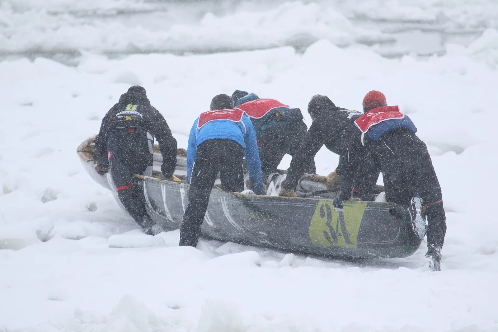 Ice canoe teams racing across the St Lawrence at the Quebec Winter Carnival